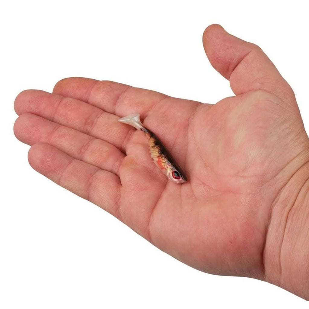 Soft perch-style fishing lure held in hand, showing red eye and speckled body