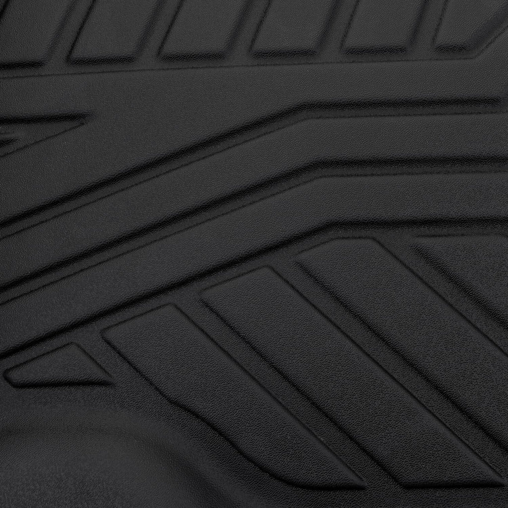 Black TPE floor mat close-up with raised non-slip ridges and channel lines