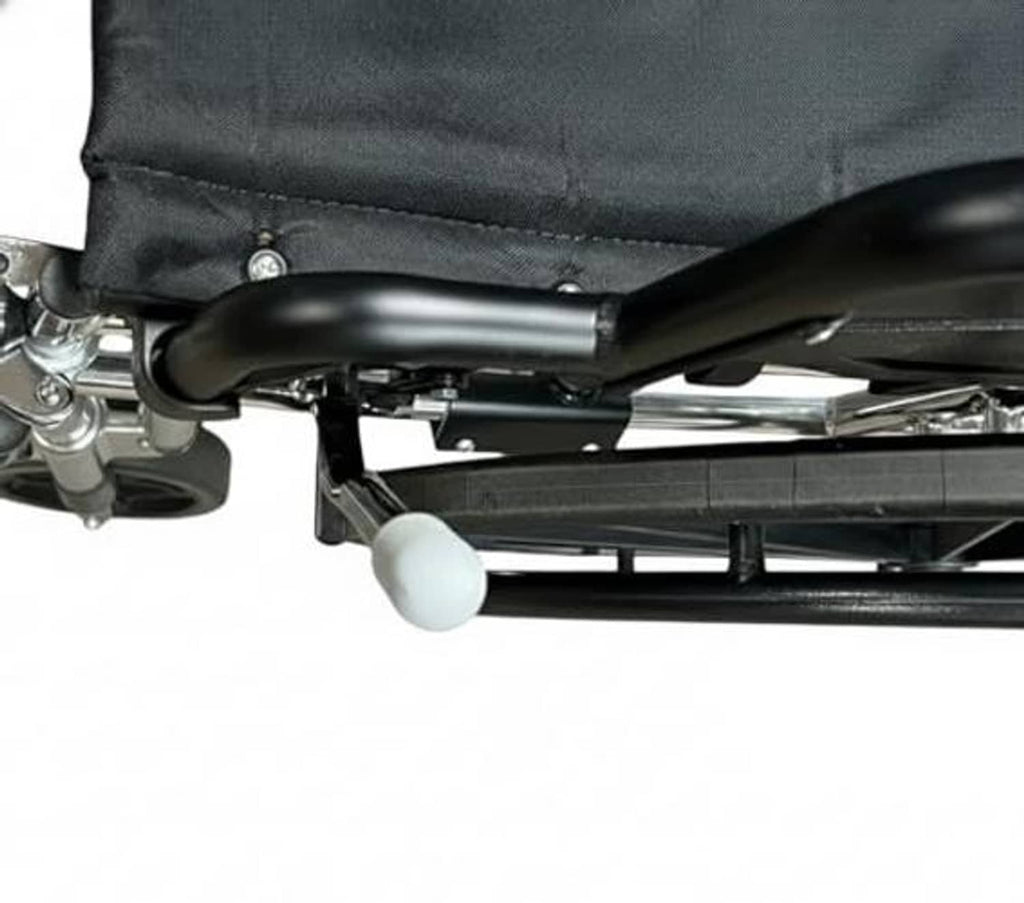 Wheelchair brake handle extension near wheel, white grip end and metal bar