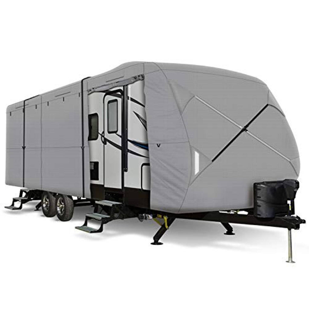 Grey travel trailer cover with cross-strap panel and front tie-down, angled view