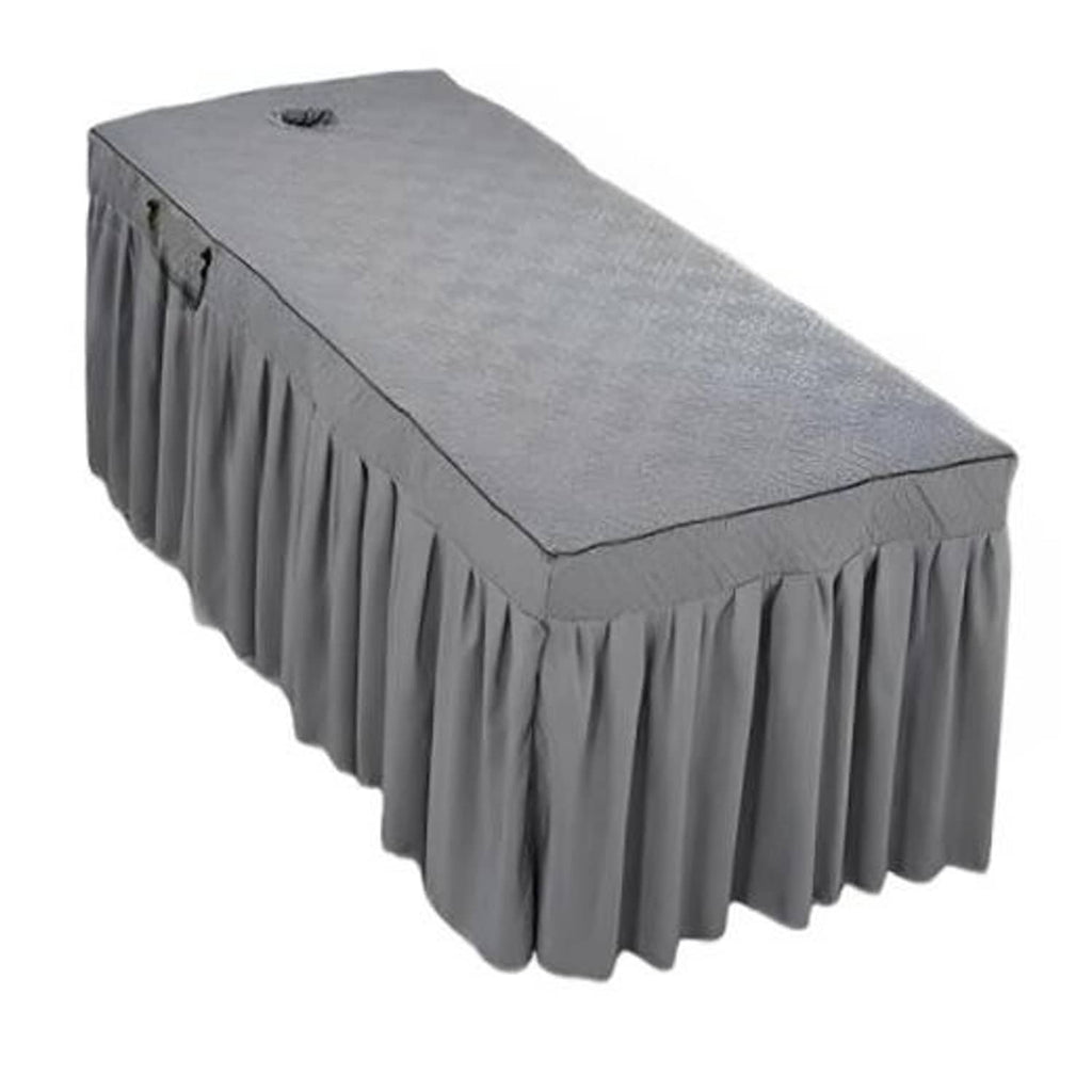 Grey quilted massage table skirt with pleated valance, fitted around table edges