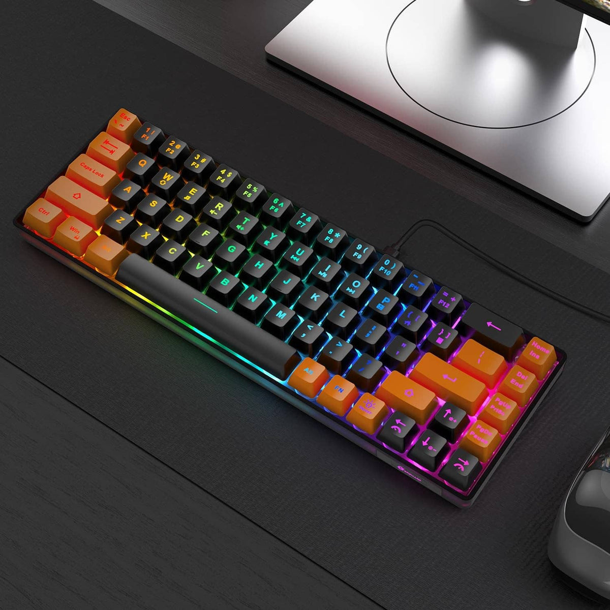 Compact wired keyboard with RGB backlit keys in black and orange keycaps