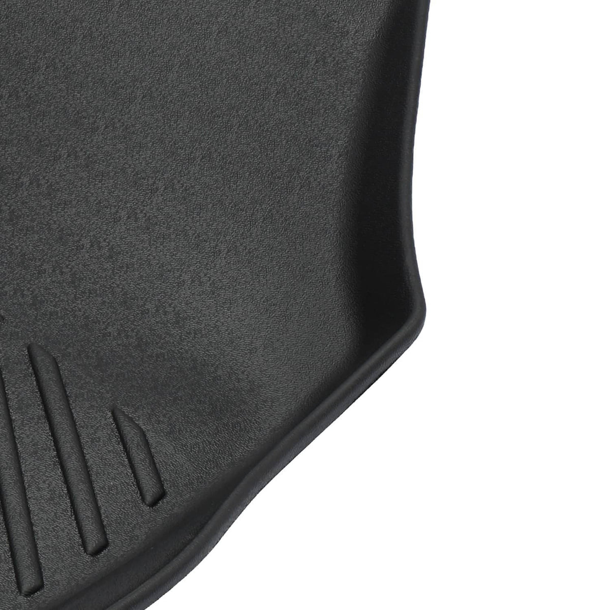 Black TPE floor mat corner with raised lip and textured grip ridges
