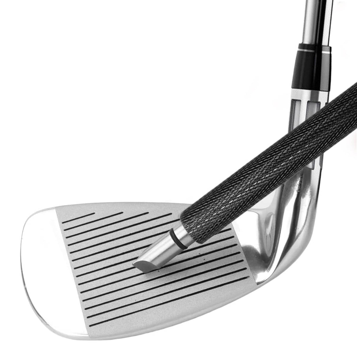 Close-up of black bristle brush cleaning grooves on a golf club head
