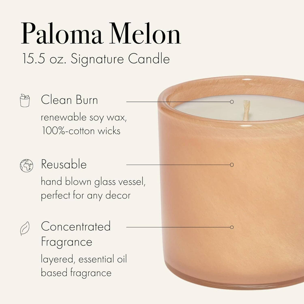 Peach amber scented candle in clear glass vessel with centered cotton wick.