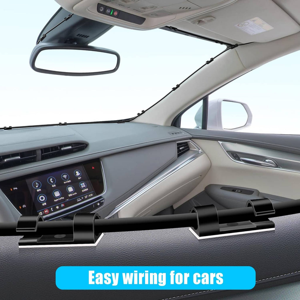 Black cable clips attached inside a car cabin to hold wires in place
