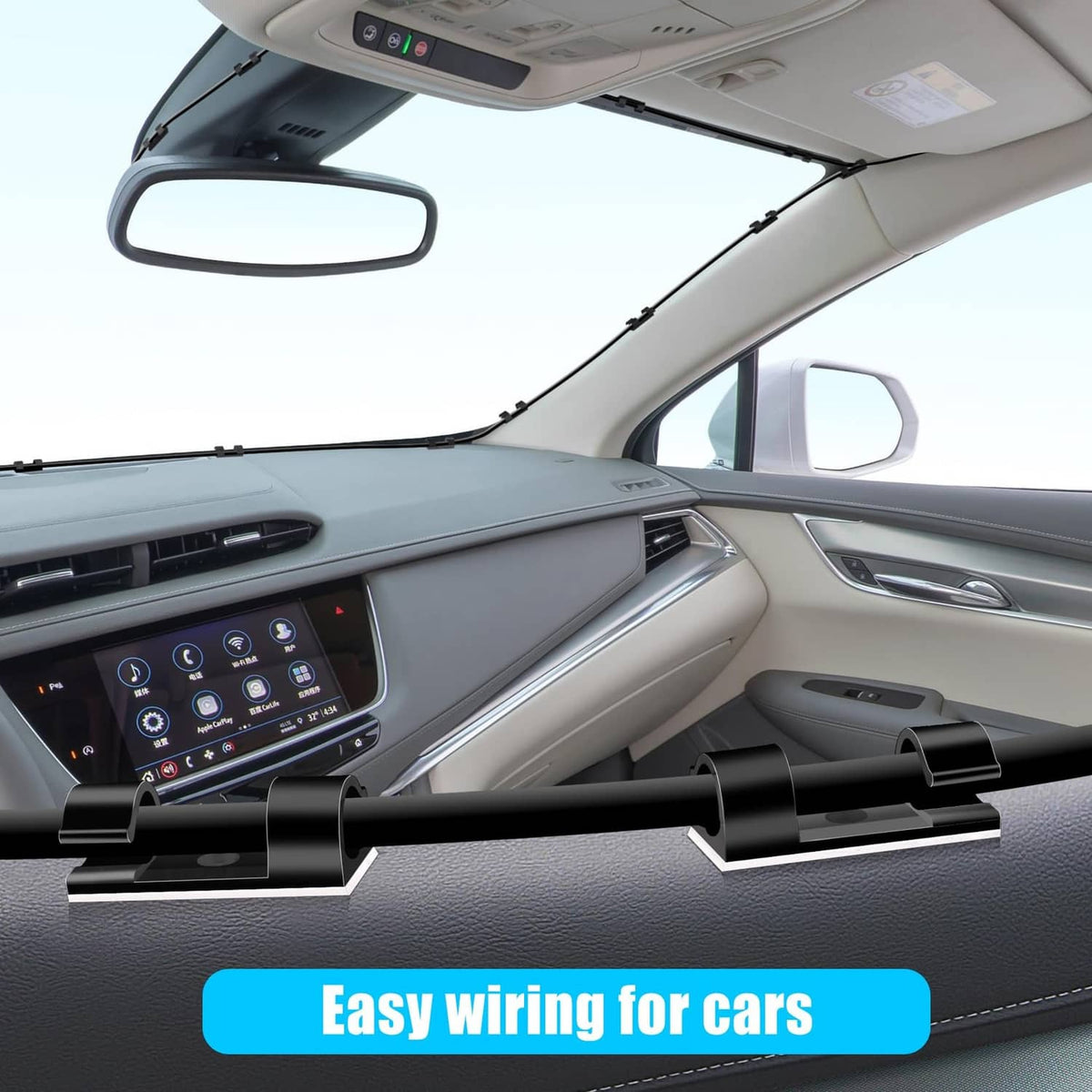 Black cable clips attached inside a car cabin to hold wires in place