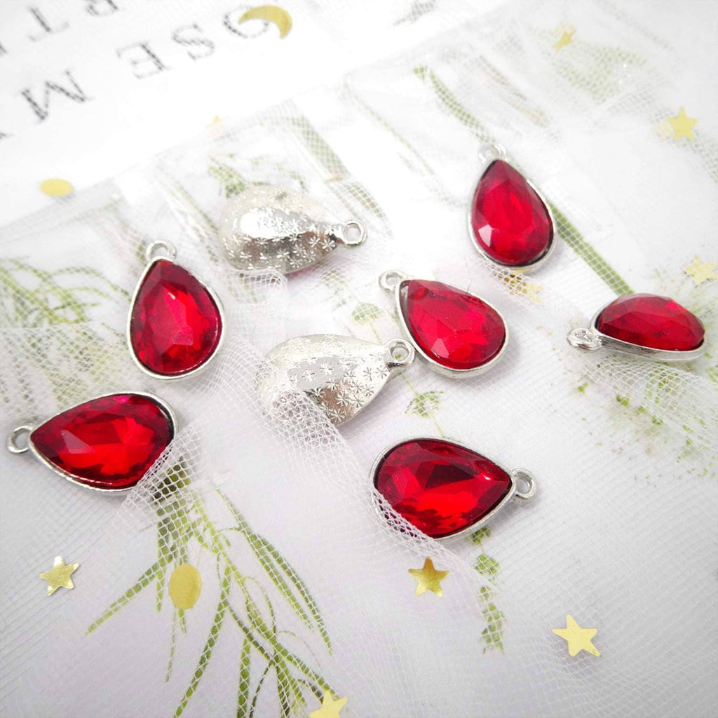 Red teardrop crystal pendant charms with silver-tone settings, multiple pieces.