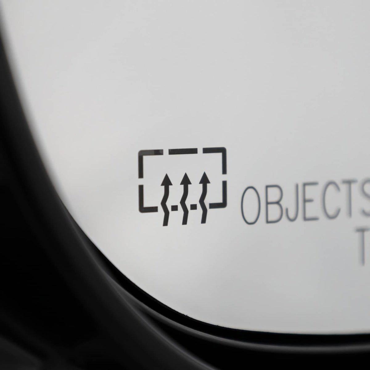 Passenger side mirror glass with distance-warning icon and black border