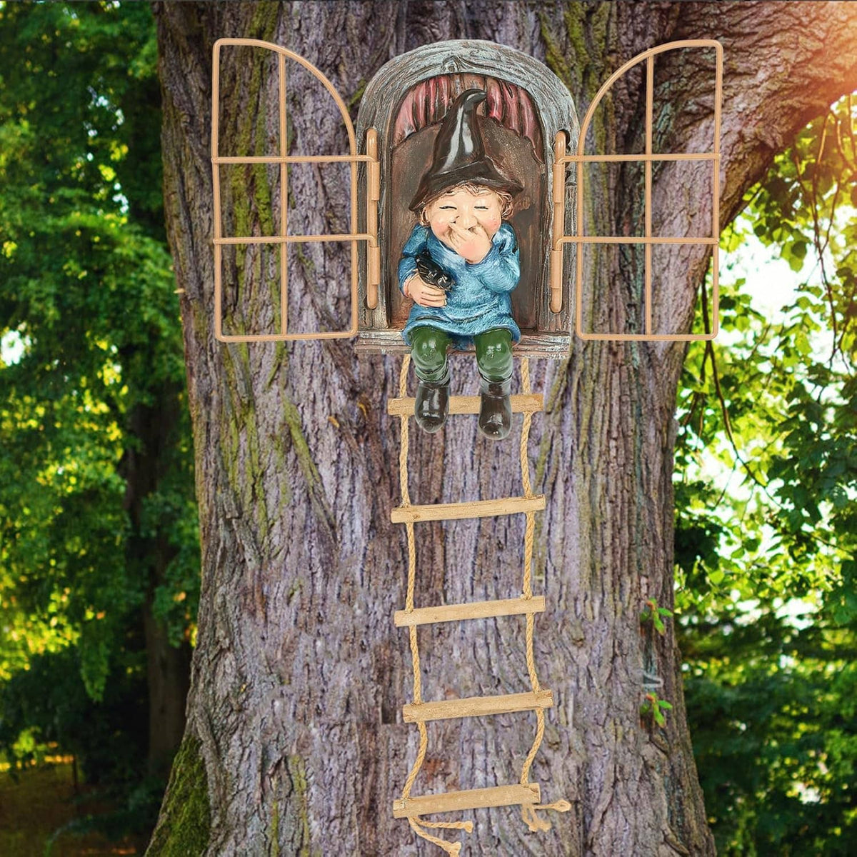 Outdoor gnome tree decoration with mesh window and hanging ladder, holding small animal.