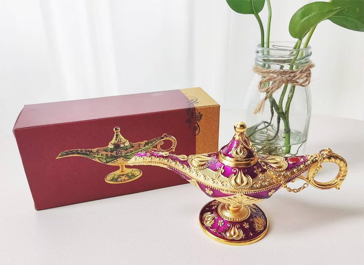 Ornate purple and gold genie lamp prop with handle chain on tabletop