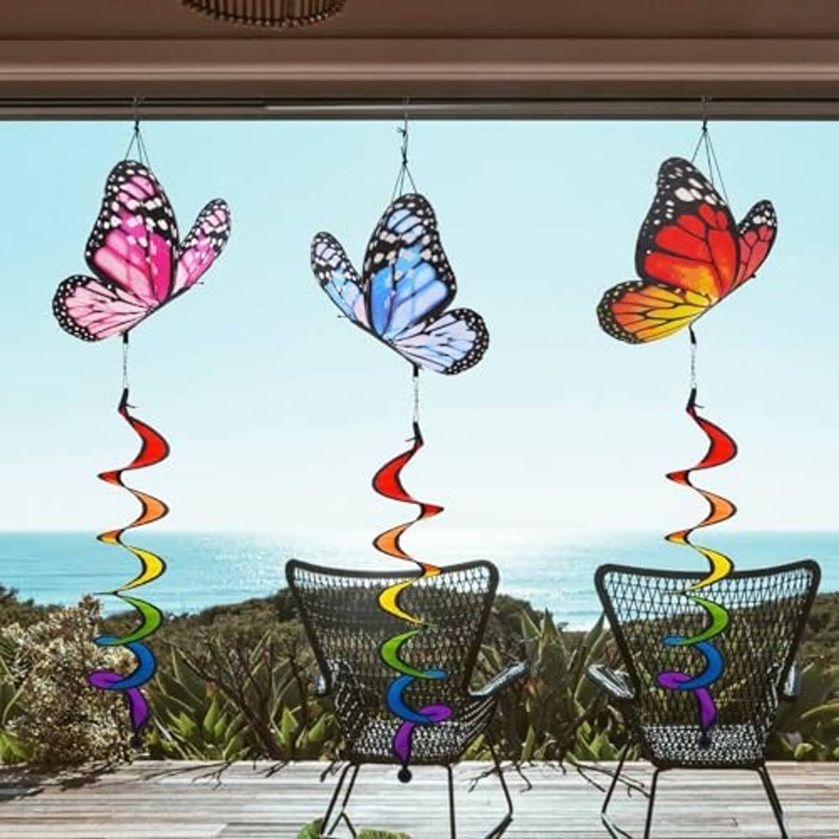 Three hanging butterfly windsocks with multicolor spiral ribbon streamers