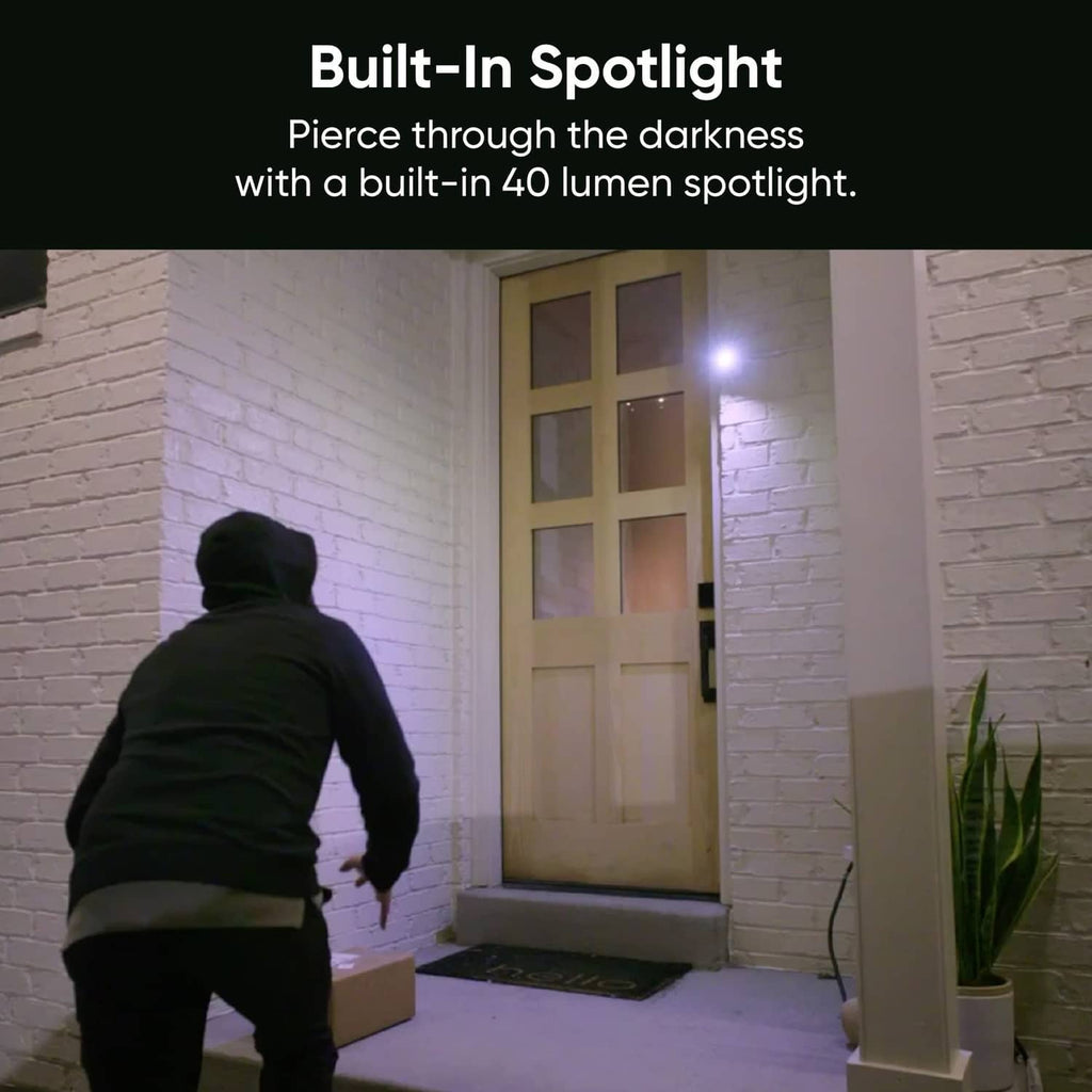 Security camera mounted near a doorway with a bright built-in spotlight