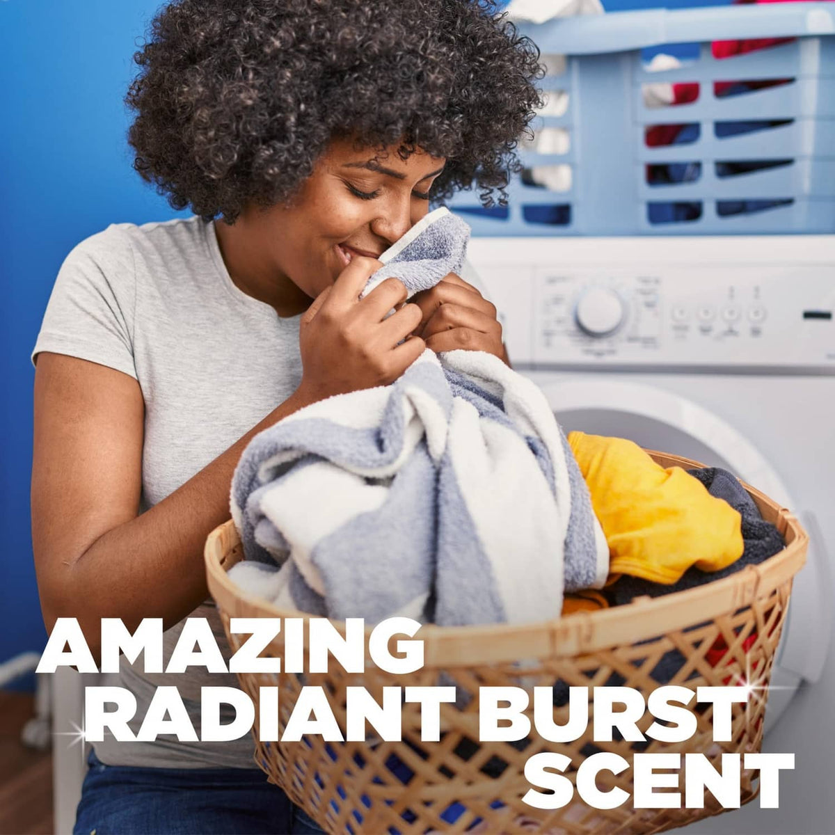 Laundry detergent concept: person holds cleaning product near a laundry basket.