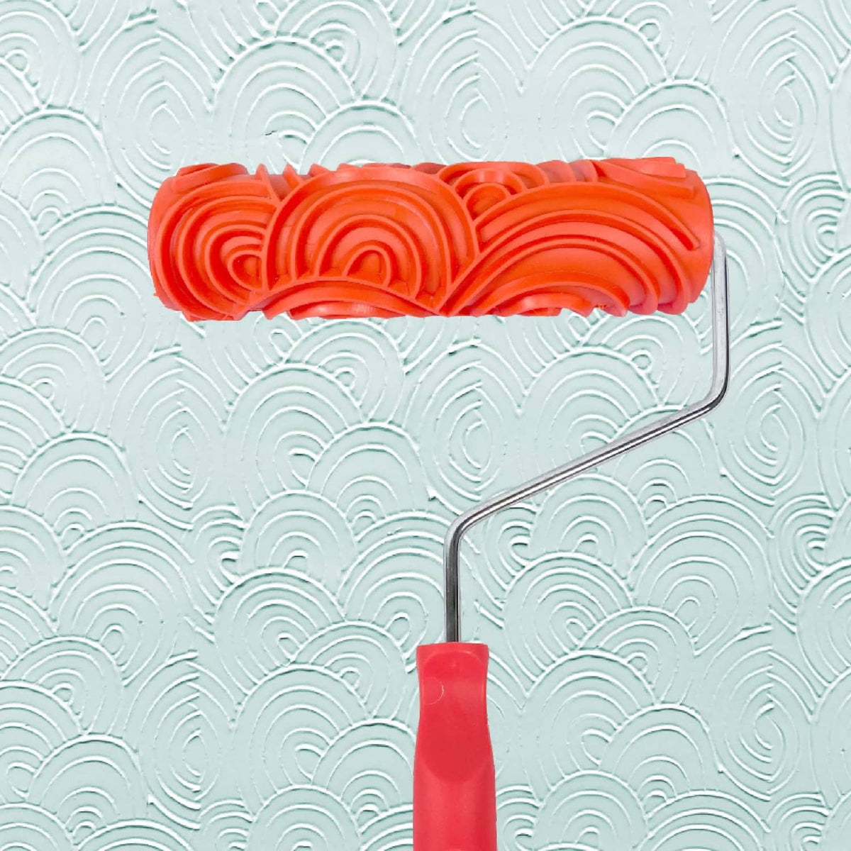 Orange patterned paint roller with raised brick texture roller head
