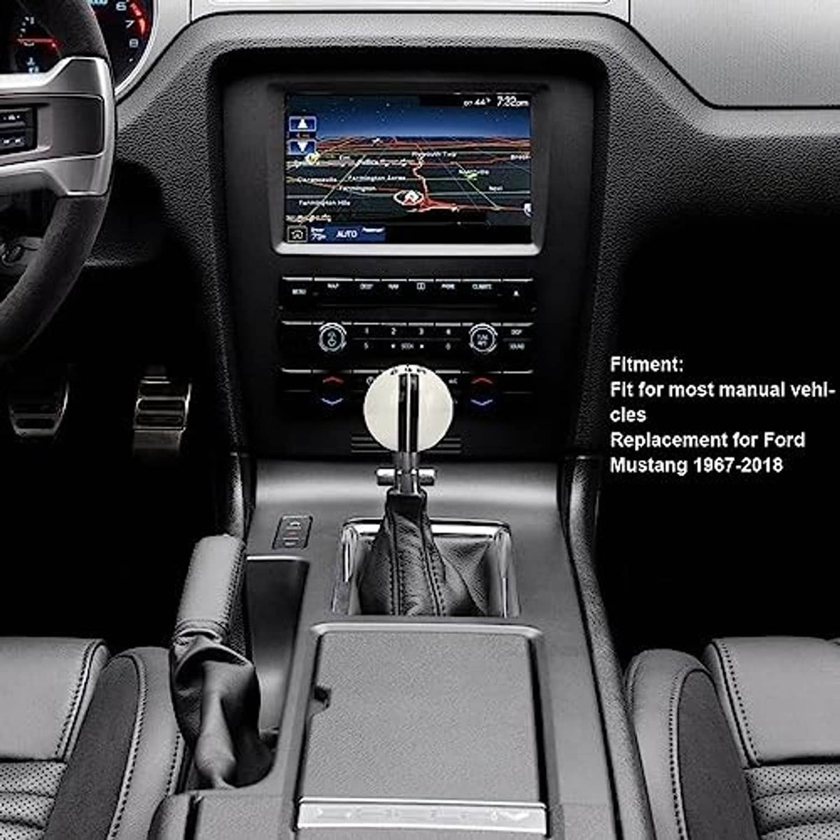 Manual gear shifter knob with white top and chrome base on dashboard controls