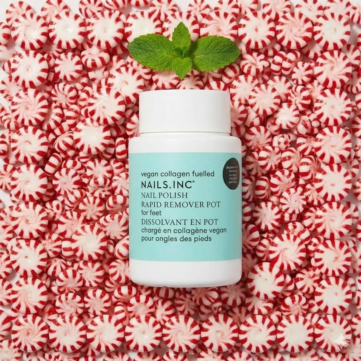 Nails.INC nail polish rapid remover pot on red and white patterned fabric