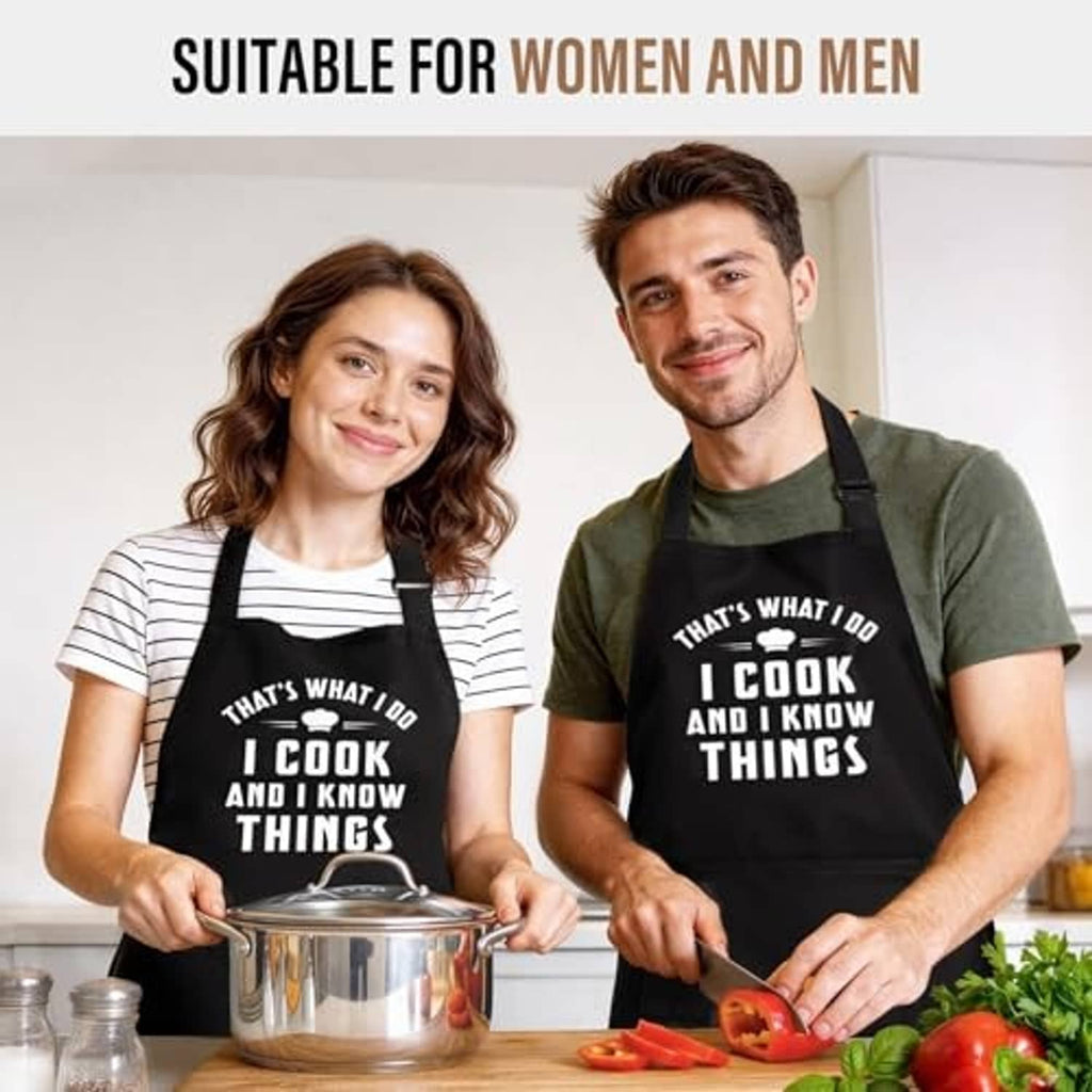 Black cooking apron with “I cook and I know things” slogan, worn by two people