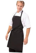 Black unisex apron worn by a man over a white shirt, front pockets and ties