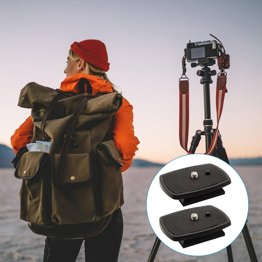 Two black tripod quick release plates with textured grip surface and central screw