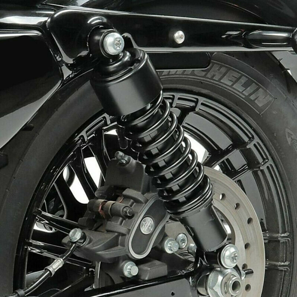 Black rear shock absorber with coil springs and mounting hardware