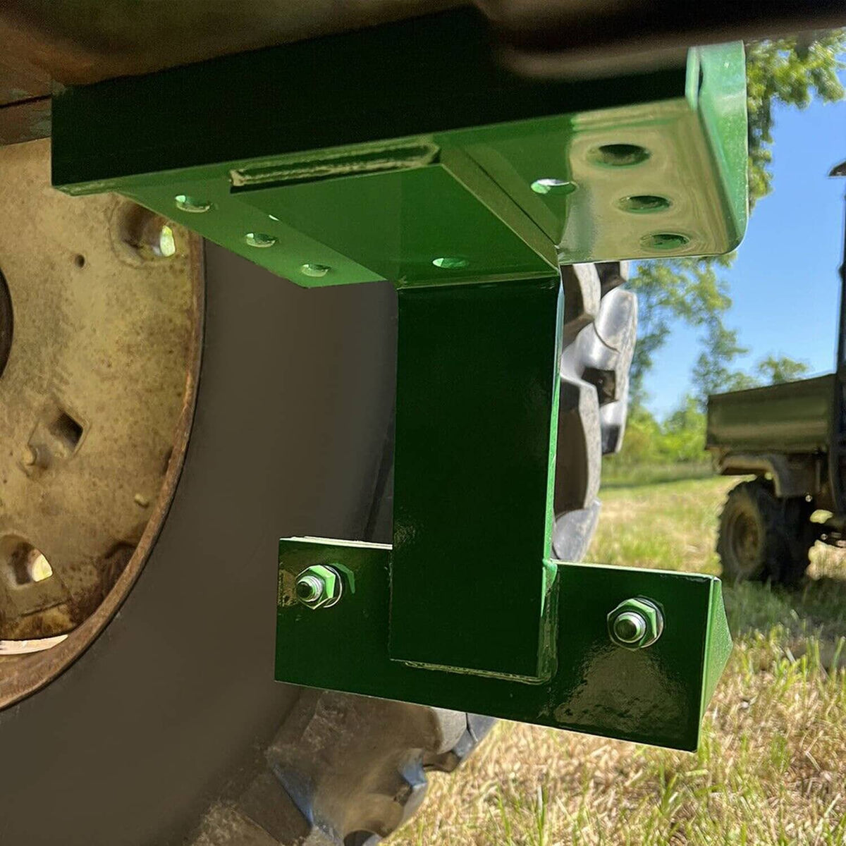 Green tractor side step bracket with attached perforated foot plate