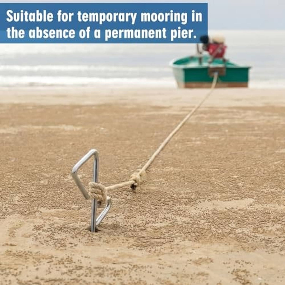 Chrome sand spike anchor with rope line, placed in sand for temporary mooring