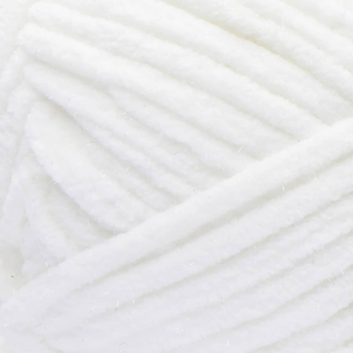 Close-up of white super bulky yarn strands with subtle sparkle texture