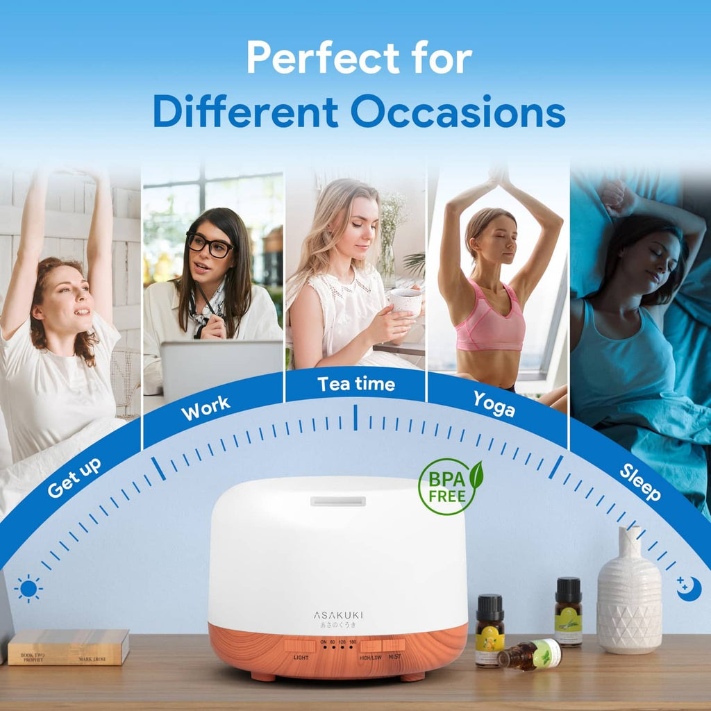 White and wood essential oil diffuser on tabletop with fragrance bottles