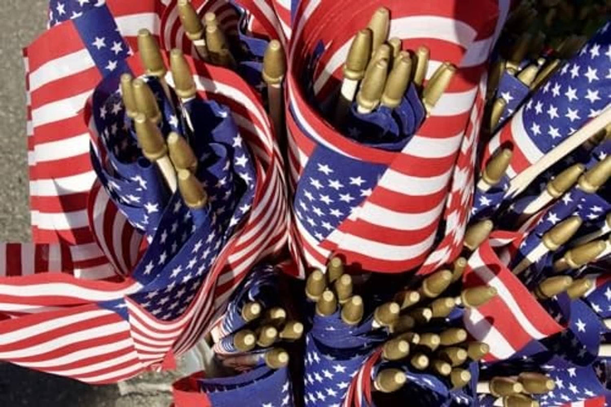 Close-up of small U.S. stick flags with gold spear tips, red white stripes and blue stars