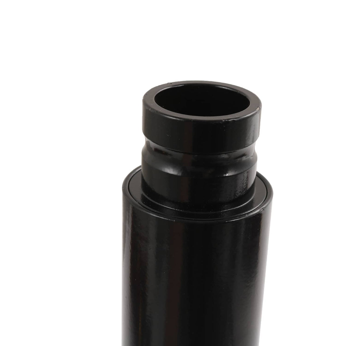 Black shock absorber body end cap with circular opening.