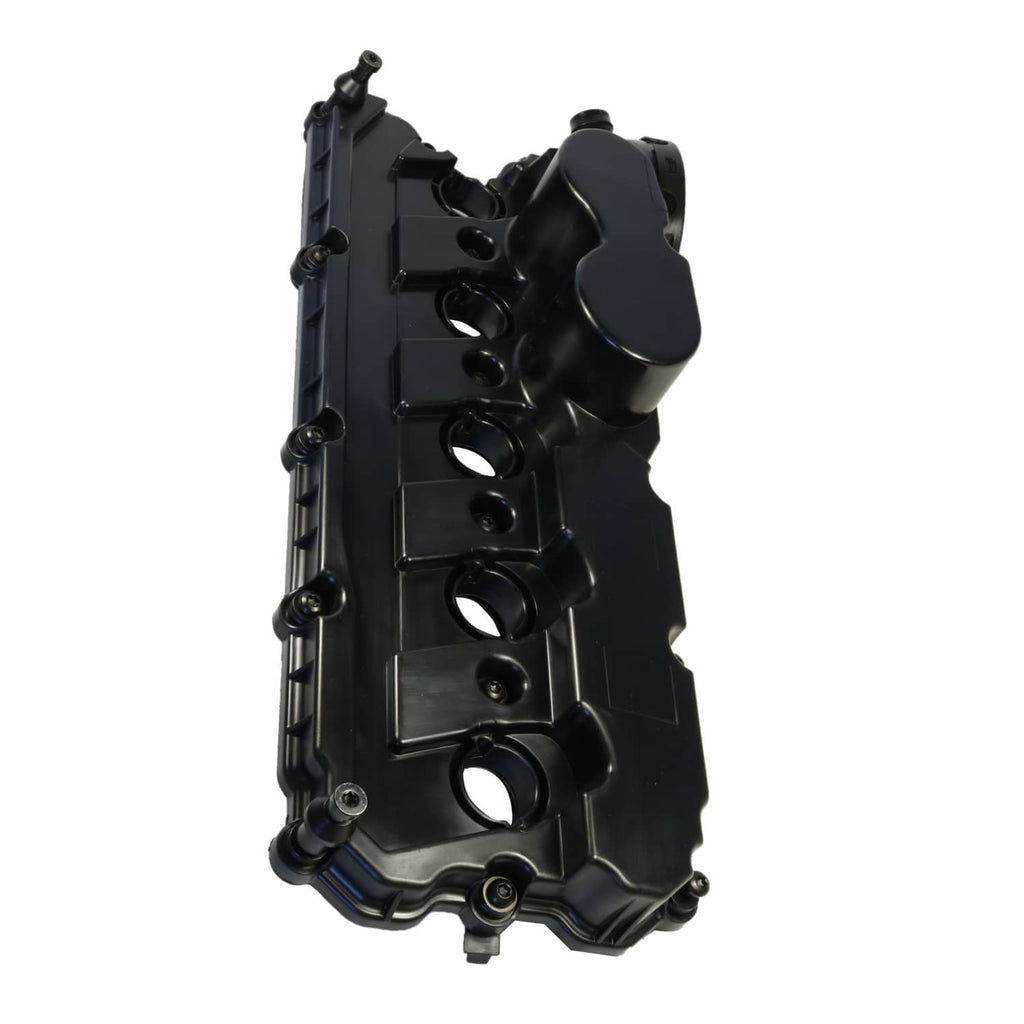 Engine valve cover underside with ports and mounting hardware, black plastic