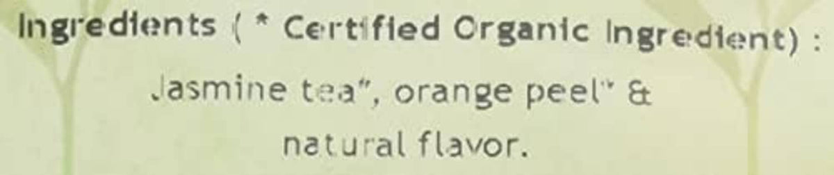 Tea pouch ingredients close-up: jasmine tea, orange peel, and natural flavor