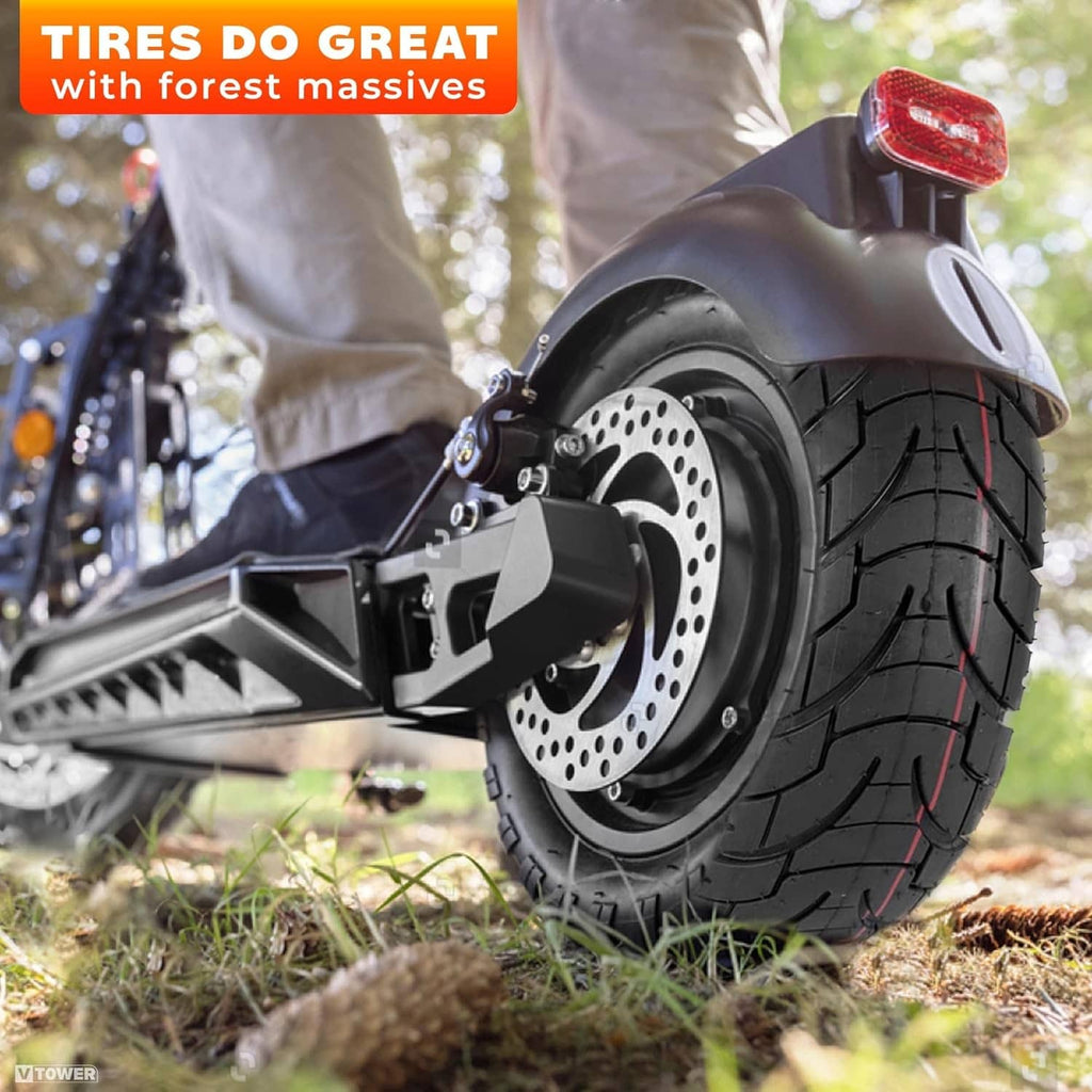 Black scooter tire with wheel rim and disc brake, rugged tread close-up