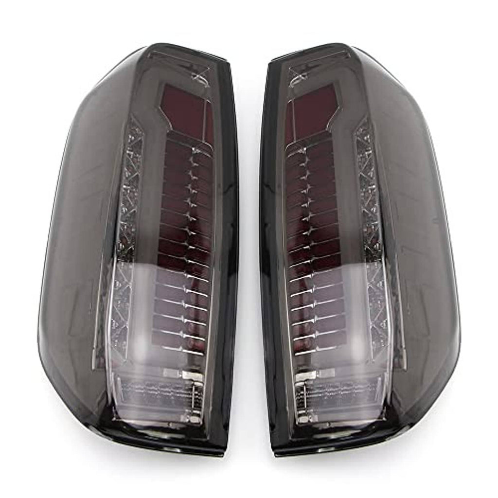 Pair of LED tail light housings with clear outer lens and red reflector elements, black finish