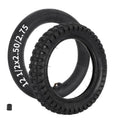 Black 12.5x2.75 tire with inner tube, textured tread, visible valve stem.