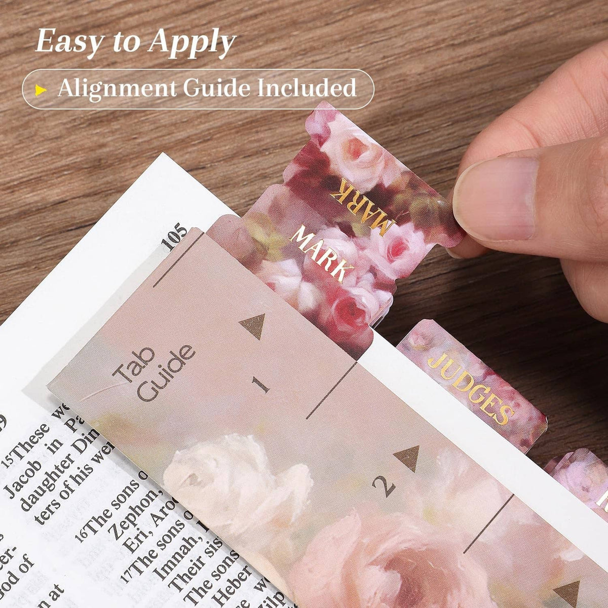 Bible tab alignment guide and pink rose floral gold-foil tab being positioned by hand.