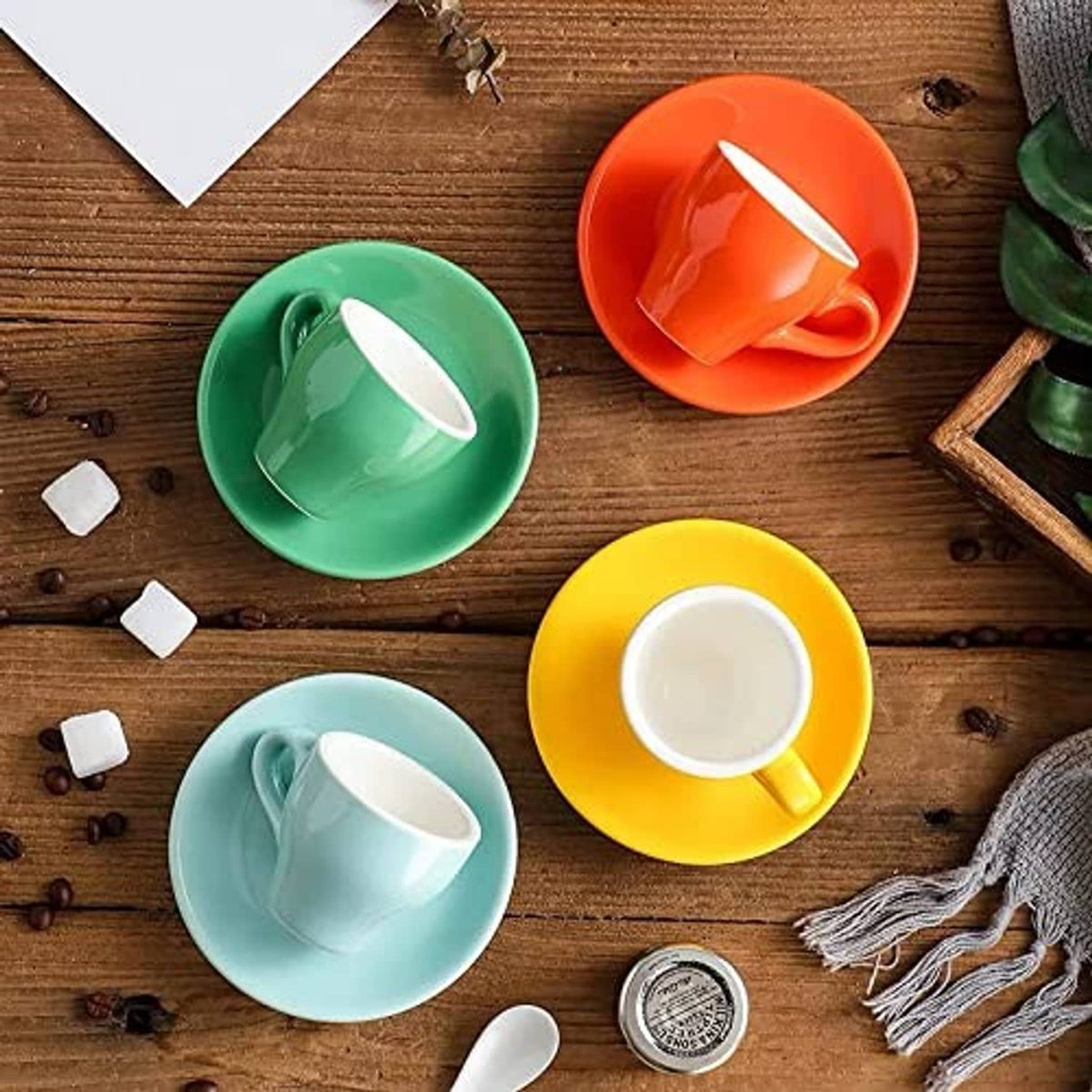Mixed-color porcelain espresso cups with matching saucers in a set