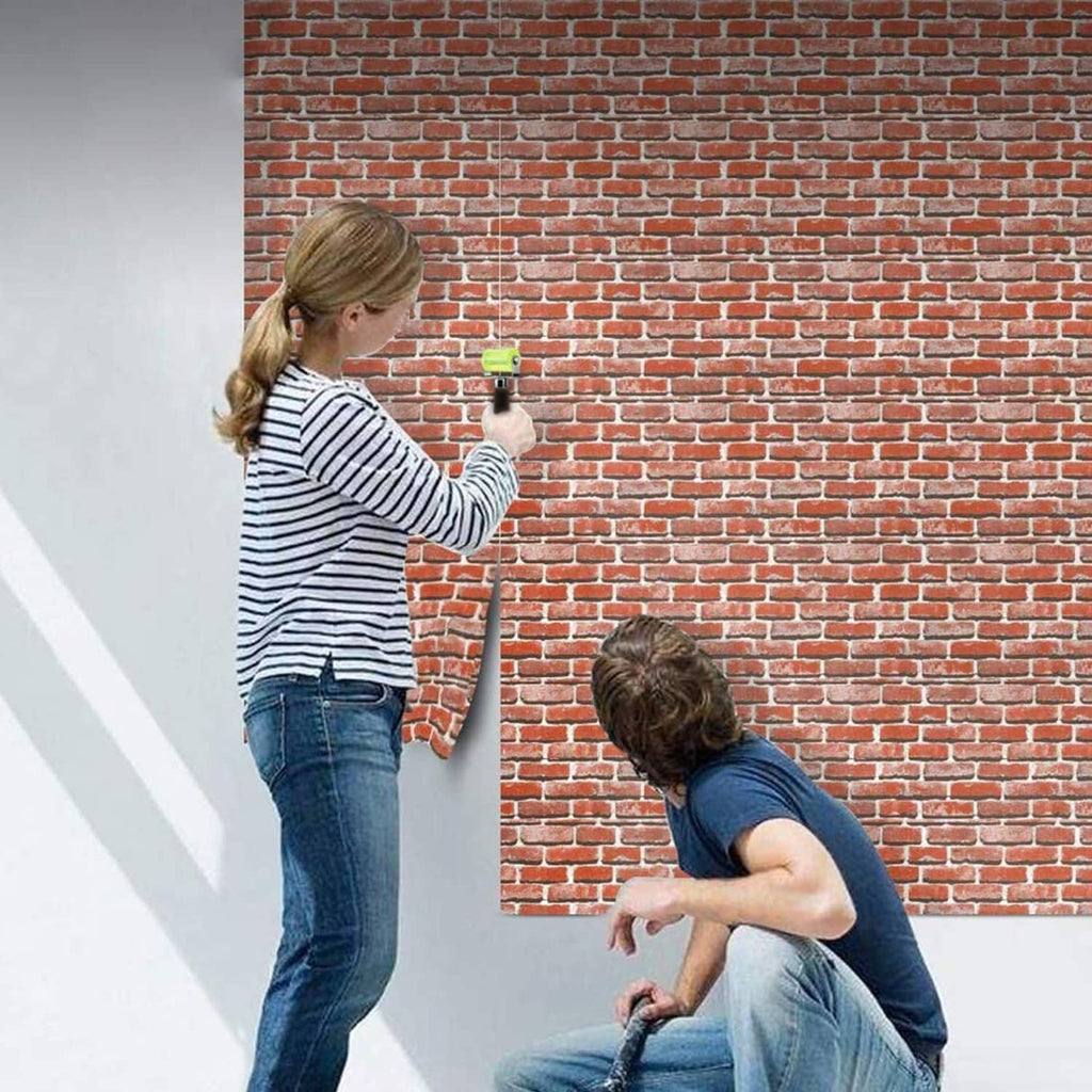 Rubber seam roller applying sealant on brick wall, lime-green wheel