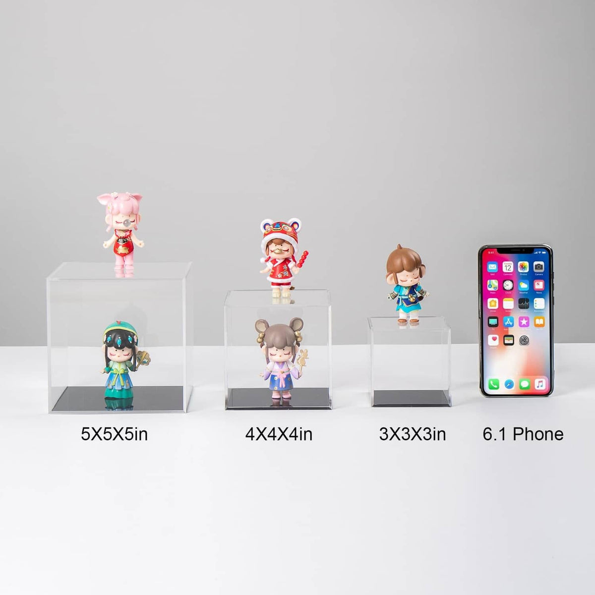 Clear acrylic display blocks showing collectibles in multiple sizes