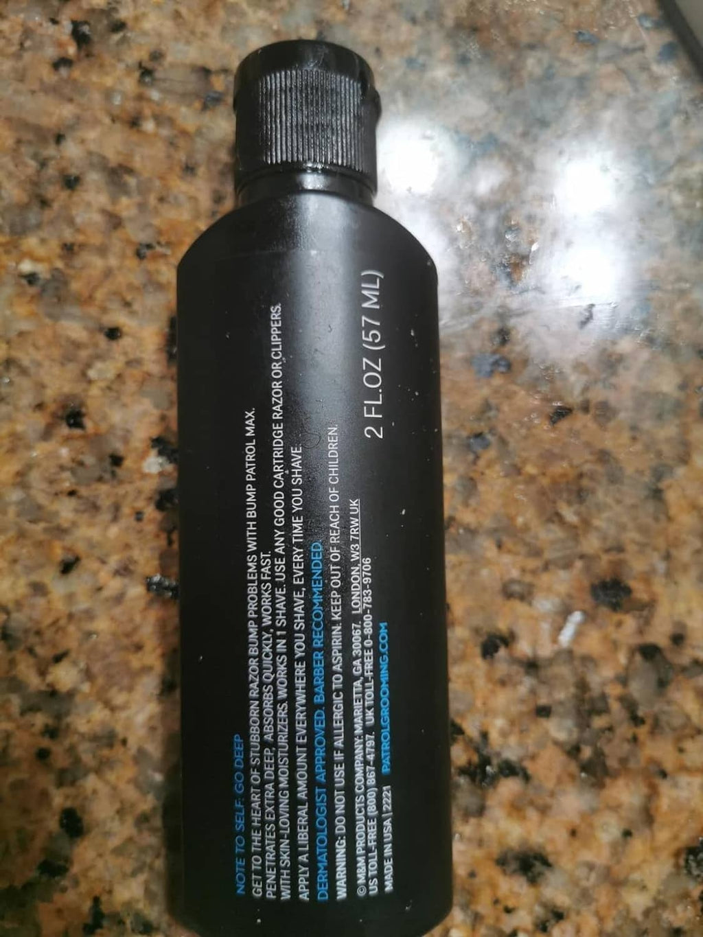Bump Patrol aftershave treatment bottle side view on countertop