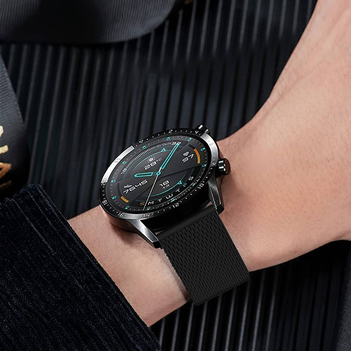 Black stainless steel mesh watch band on a wrist with round watch case