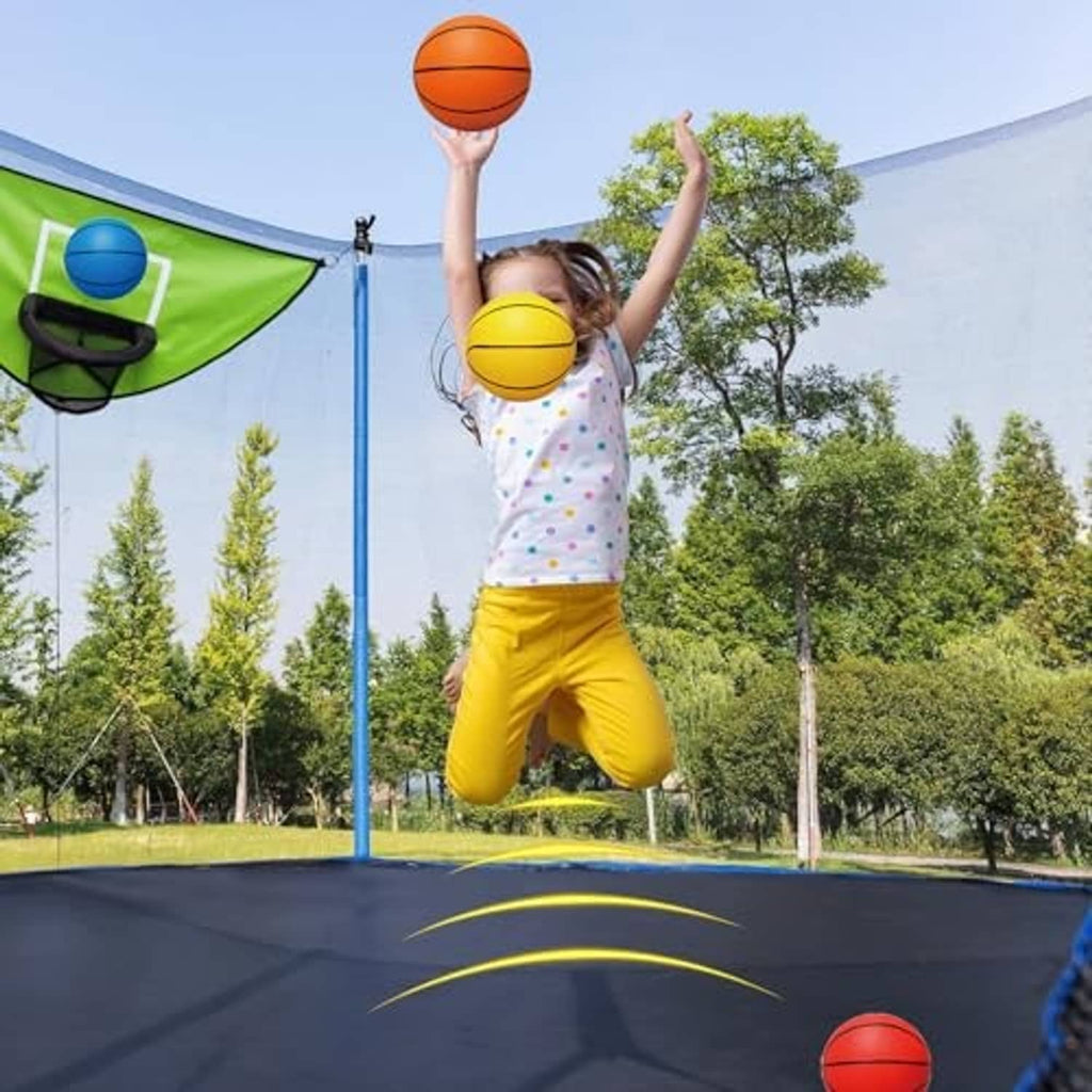 Trampoline basketball hoop with four mini balls as a child dunks a ball