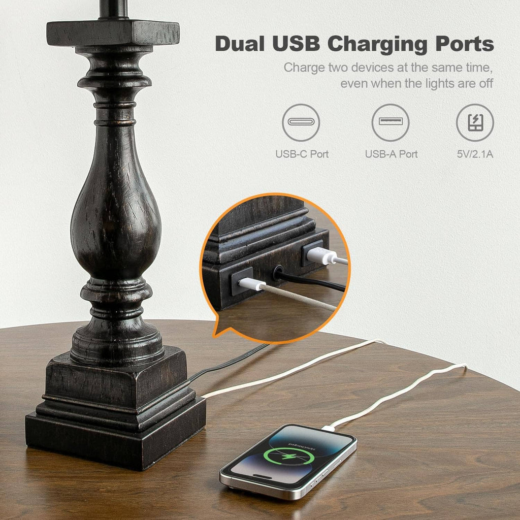 Close-up of black table lamp base with dual USB-C and USB-A charging ports