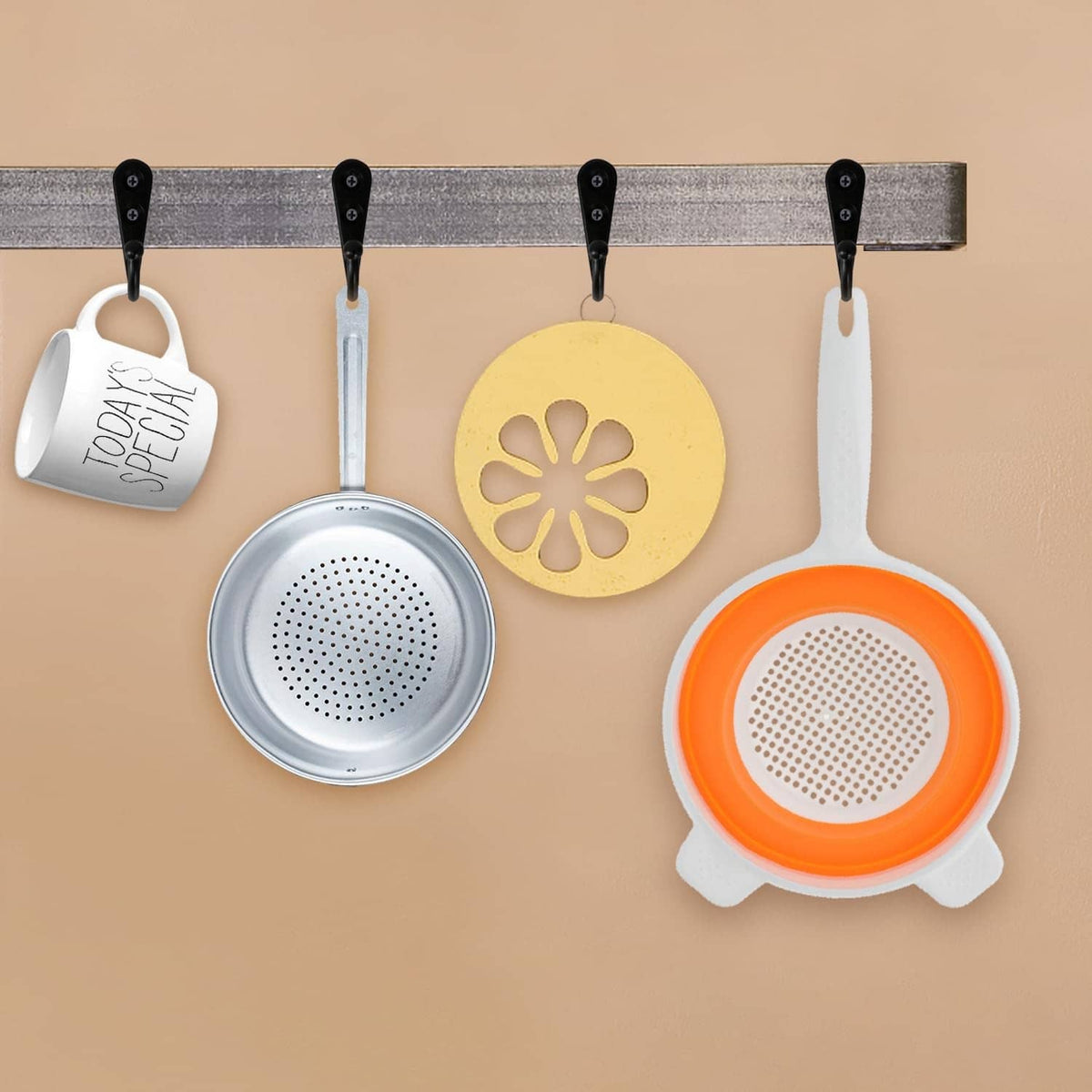 Black wall coat hooks with screw plates, holding kitchen items on a board