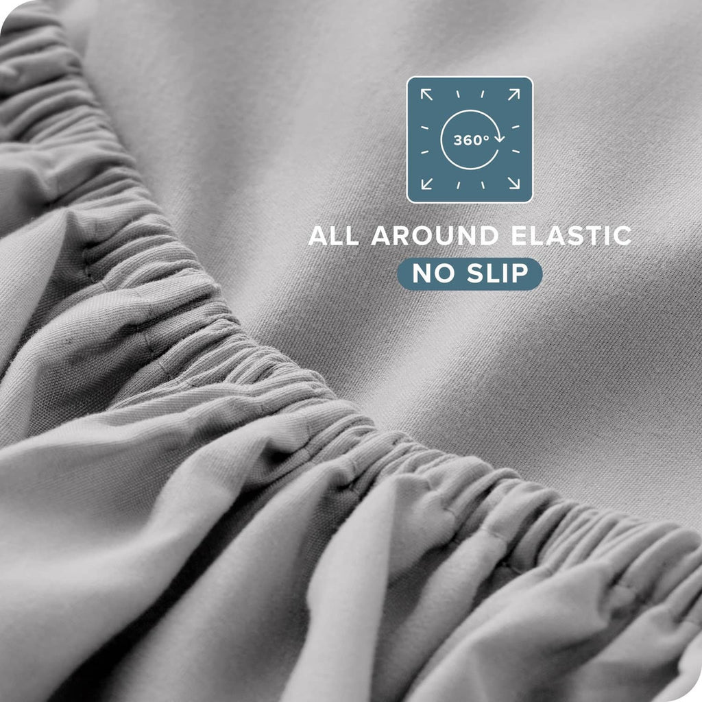 Light grey fitted sheet corner with all-around elastic, close-up no-slip