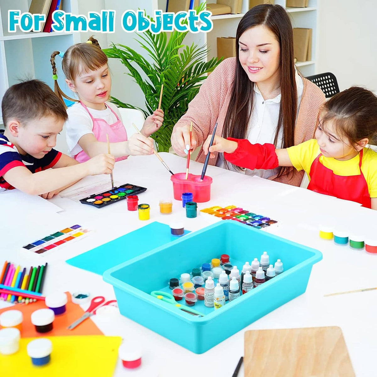 Teal plastic tray organizer on a classroom table for art supplies