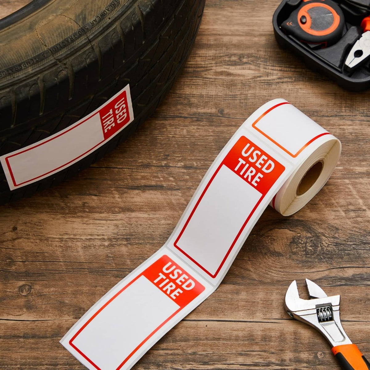 Red USED TIRE label stickers on wood, label strip and roll with blank boxes