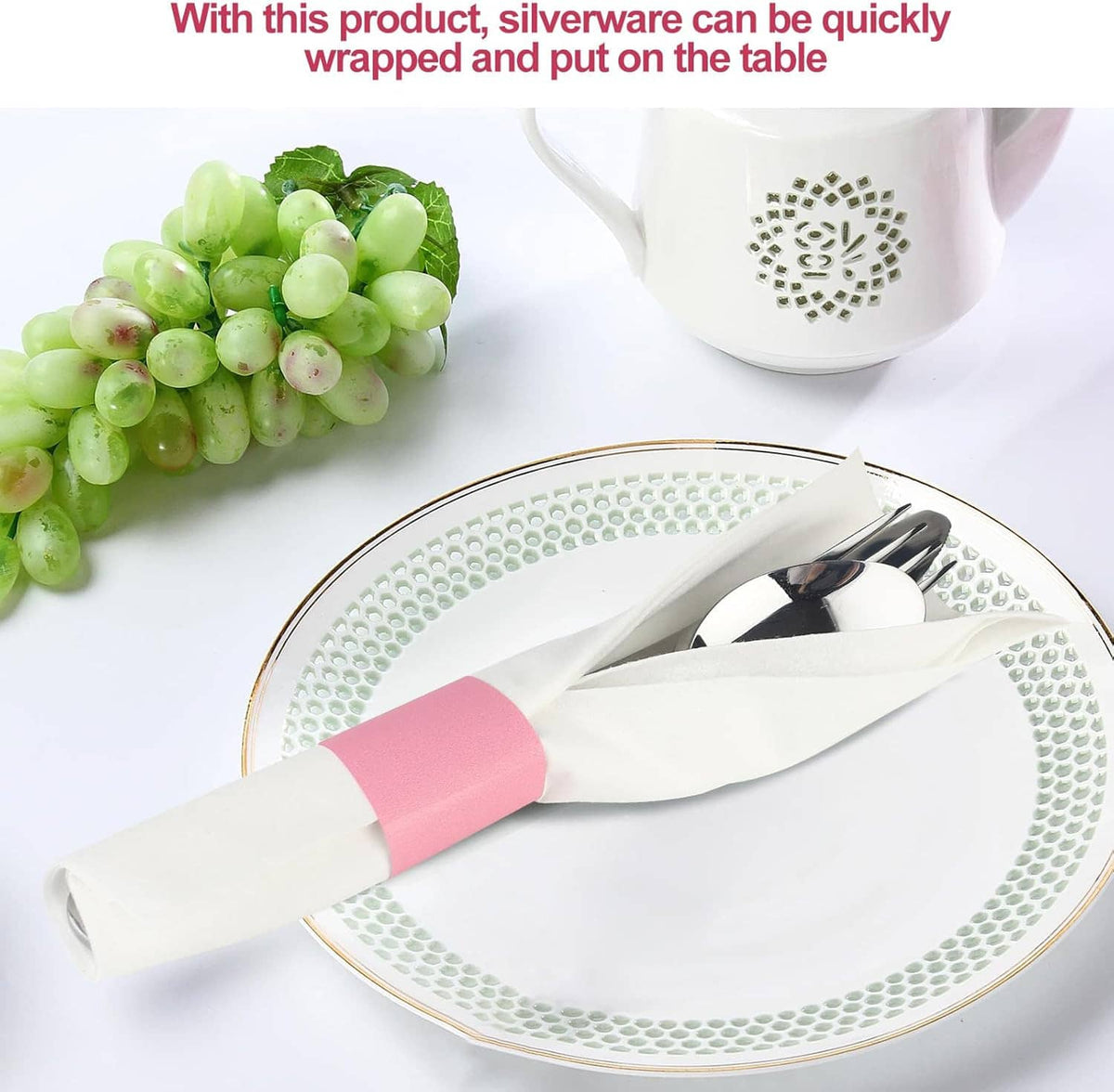 Pink napkin band securing wrapped silverware on a plate