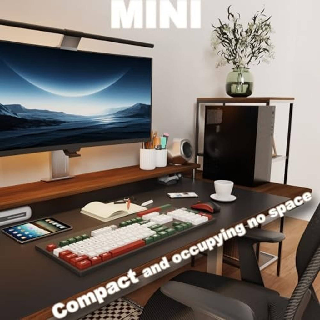 Compact black PC tower case on a desk under a monitor beside a keyboard